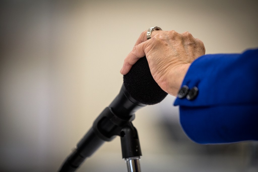 Sen. Mazie Hirono puts her hand over microphone as she speaks with an aide during a Senate Veteran's Affairs Committee Field Hearing at the Oahu Veterans Center on August 19, 2014.