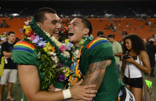 LEFT, UH Rainbow Warrior Senior #12 Jeremy Higgins shares a light moment with RIGHT, #11 Ikaika Woolsey after the last home game of the season. 22 nov 2014 ALOHA STADIUM, HONOLULU, HAWAII. photo CORY LUM/ CIVIL BEAT