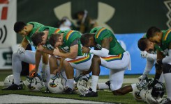 Some UH Hawaii Rainbow Warriors pray in the north end zone before the start of the game against UNLV .  ALOHA STADIUM, HONOLULU, HAWAII. photo CORY LUM/ CIVIL BEAT