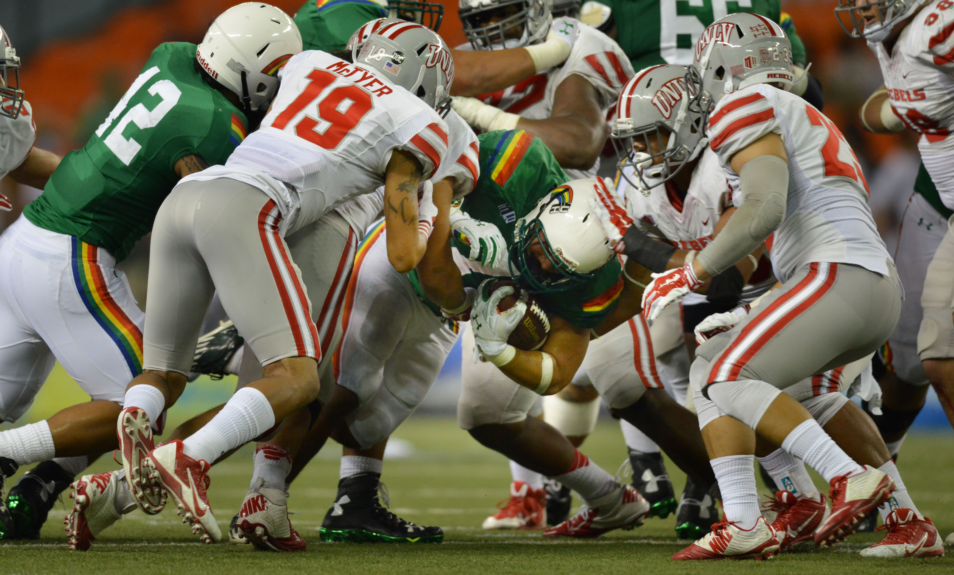 UNLV defensive attempts to stop Hawaii Rainbow Warriors in the first half of action at Aloha Stadium. ALOHA STADIUM, HONOLULU, HAWAII. photo CORY LUM/ CIVIL BEAT