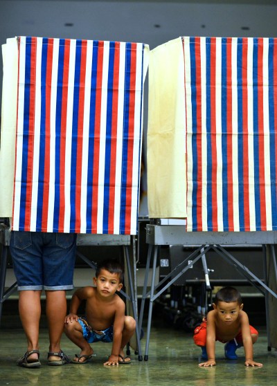 Right, 3-year-old Lucan Keawe-Kekoa plays with left, brother 5-year-old Aliiokekai Keawe-Kekoa while mom, Cassandra Kekoa casts her vote at Nanaikapono Elementary School located at 89-153 Mano Avenue in Waianae, Hawaii. 4 November 2014. photography by Cory Lum
