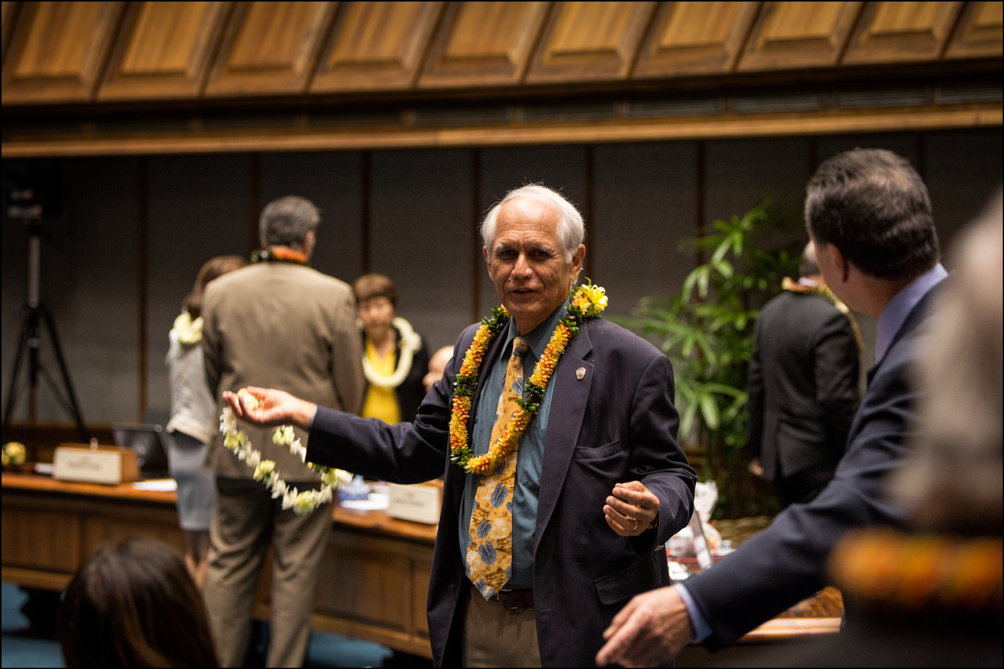 Sen. Mike Gabbard gives fellow Sen. Clayton Hee a lei before the start of the last day of the legislative session. 5.1.14 ©PF Bentley/Civil Beat