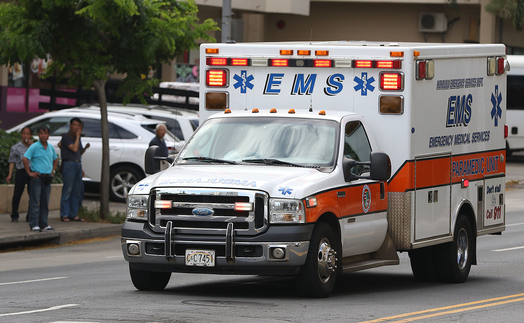 City and County EMS ambulance heads down Beretania Street near Chinatown with sirens and lights flashing. 4 june 2015. photograph Cory Lum/Civil Beat