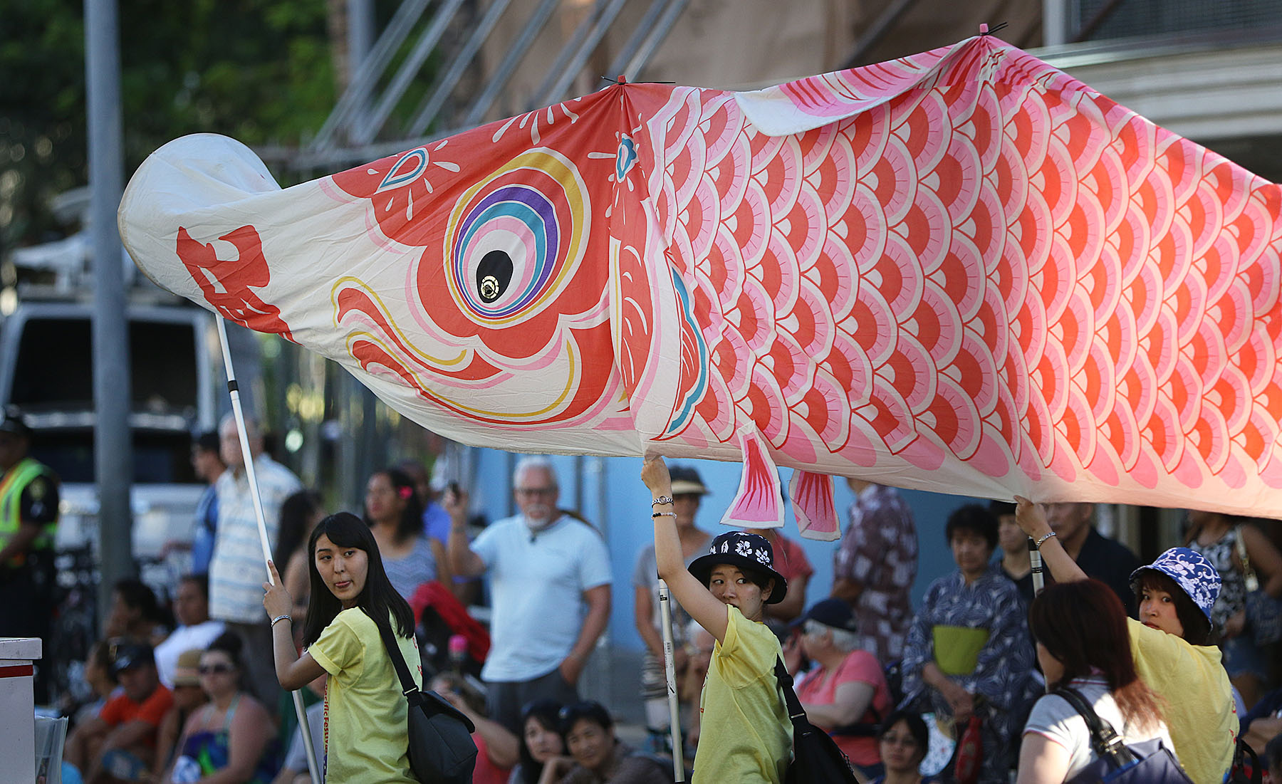 Members from the Yosakoi Mai Friends hoist a large red 'Koi' or carp during the 2015 Pan-Pacific Festival Parade along Kalakaua Avenue. Waikiki, Hawaii. 14 june 2015. photograph Cory Lum/Civil Beat