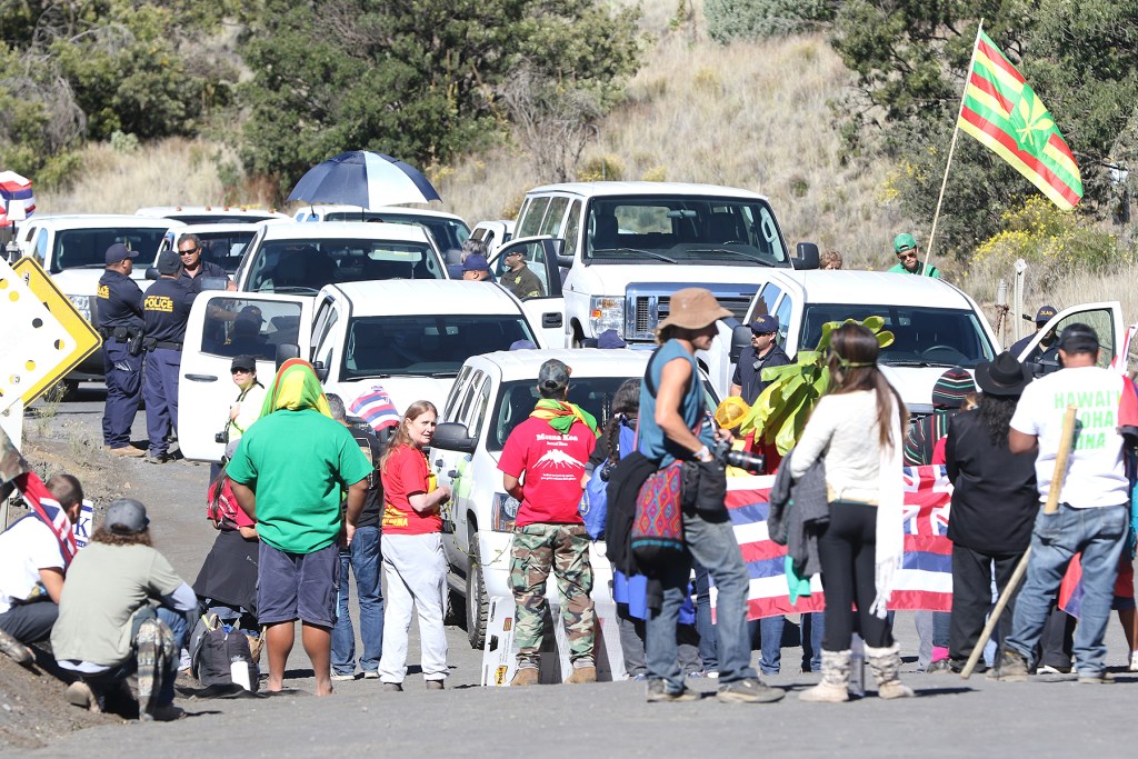 DLNR vehicles are stopped at the bottom of the road leading to the summit of Mauna Kea early in the morning. The demonstrators strategized by having many layers of supporters, creating a barrier against TMT workers trying to reach the summit. 24 june 2015. photograph Cory Lum/Civil Beat