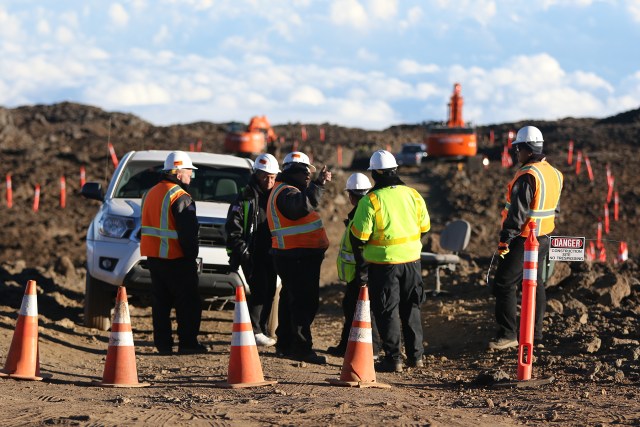 Private security personnel stand at road leading to the TMT work site atop Maunakea. 24 juen 2015. photograph Cory Lum/Civil Beat