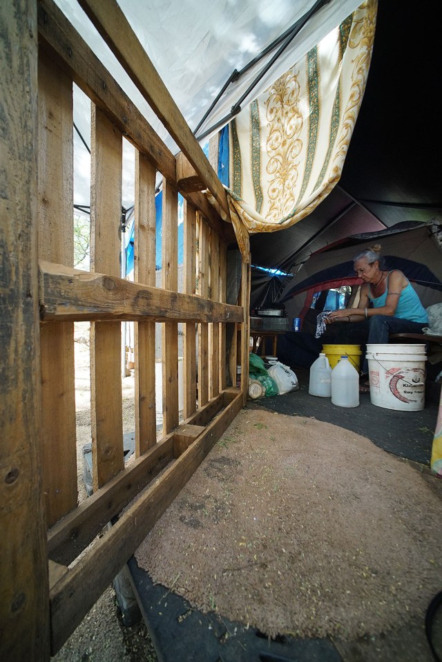 Lee Ann washes clothes using a bucket system in her tent.