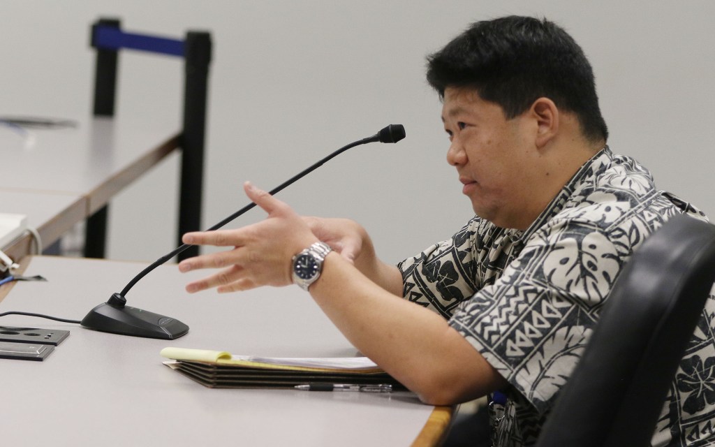 Deputy AG Landon Murata gestures while offering some advice to Sen Roslyn Baker, Sen Will Espero and Chair Clarence Nishihara.