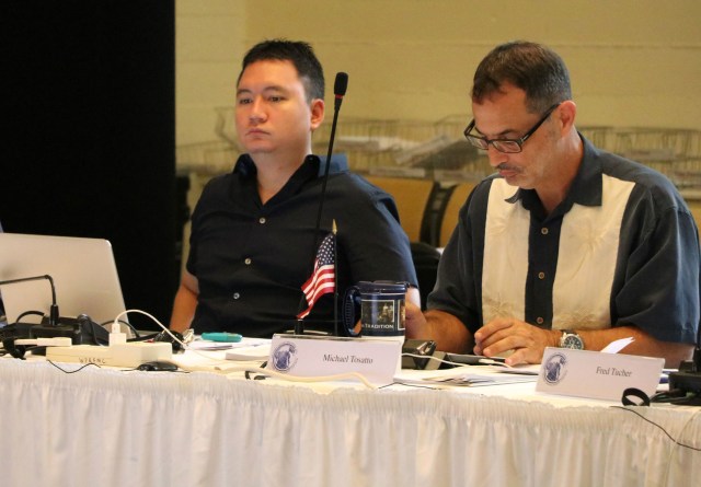 Michael Goto, left, of the United Fishing Agency, and Michael Tosatto, regional administrator of the National Marine Fisheries Service, listen during a Western Pacific Regional Fishery Management Council meeting, Oct. 13, 2016, in Honolulu. 