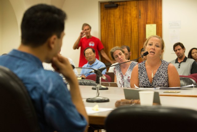 Rep. Kaniela Ing, left, asks listens to a Ashley Watts, a former federal fish observer who spent time on commercial fishing vessels.