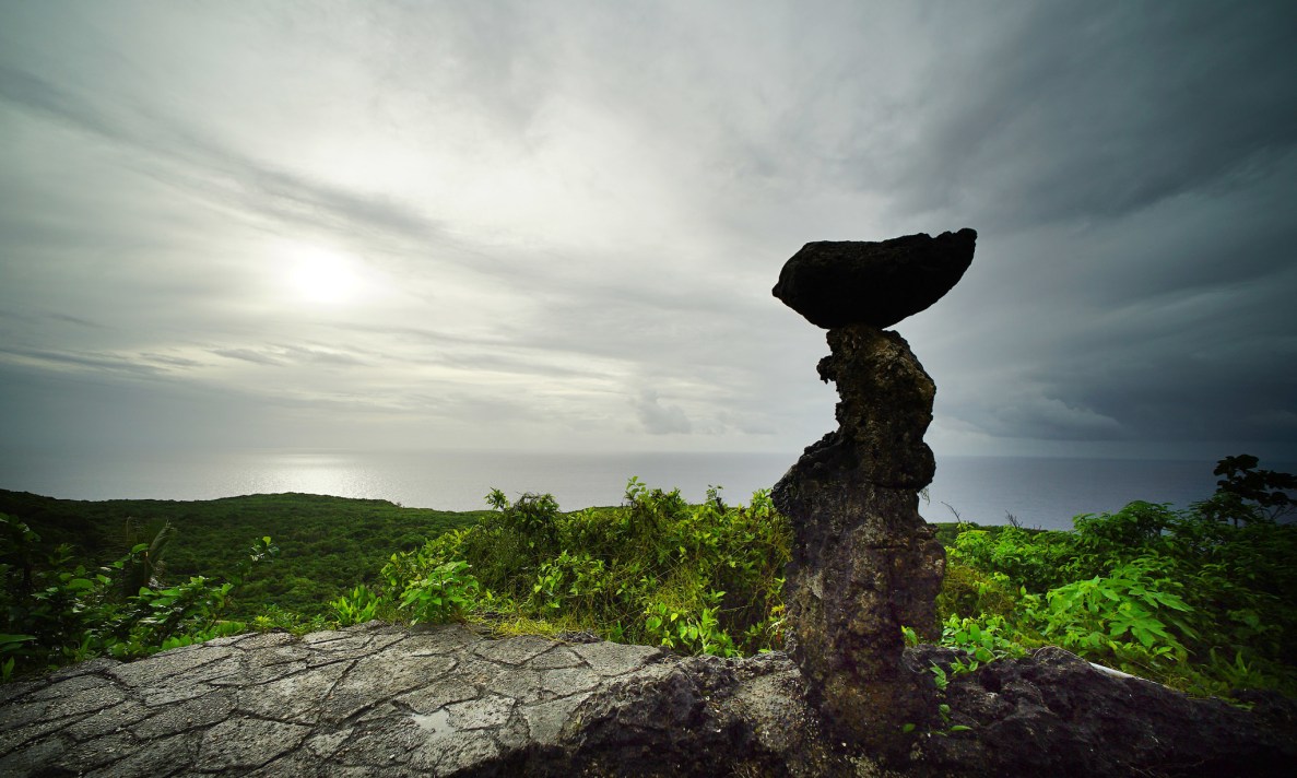 Attorney Leevin Camacho with 'We are Guahan' silhouetted near overlook of Pagat, Saipan.Marianas. 23 aug 2016