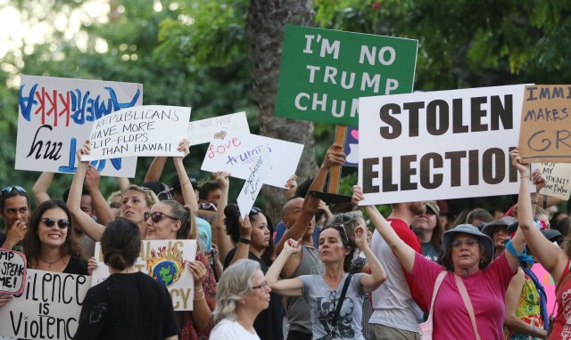 Hundreds of 'Love Trumps Hate' rally supporters crowd across the street of Trump International Hotel Waikiki after marching from Kapiolani Park. 13 nov 2016