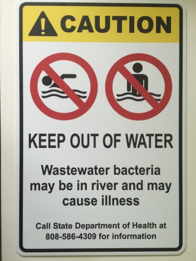 A Kauai nonprofit modeled this sign after the Health Department's own signs and placed it at a site on the south shore of Kauai that regularly exceeds safe limits of fecal-matter bacteria. The state took it down and replaced it with a laminated piece of paper in August that says: “HIGH BACTERIA levels here, especially in days after rainfall events. Contact with water may cause illness.”