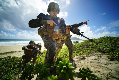 fault lines US Marines storm Pyramid Rock Beach Marine Corps Base Hawaii after landing on beach via Amphibious Assault Vehicles in RIMPAC exercises. Kaneohe Hawaii. 30 july 2016