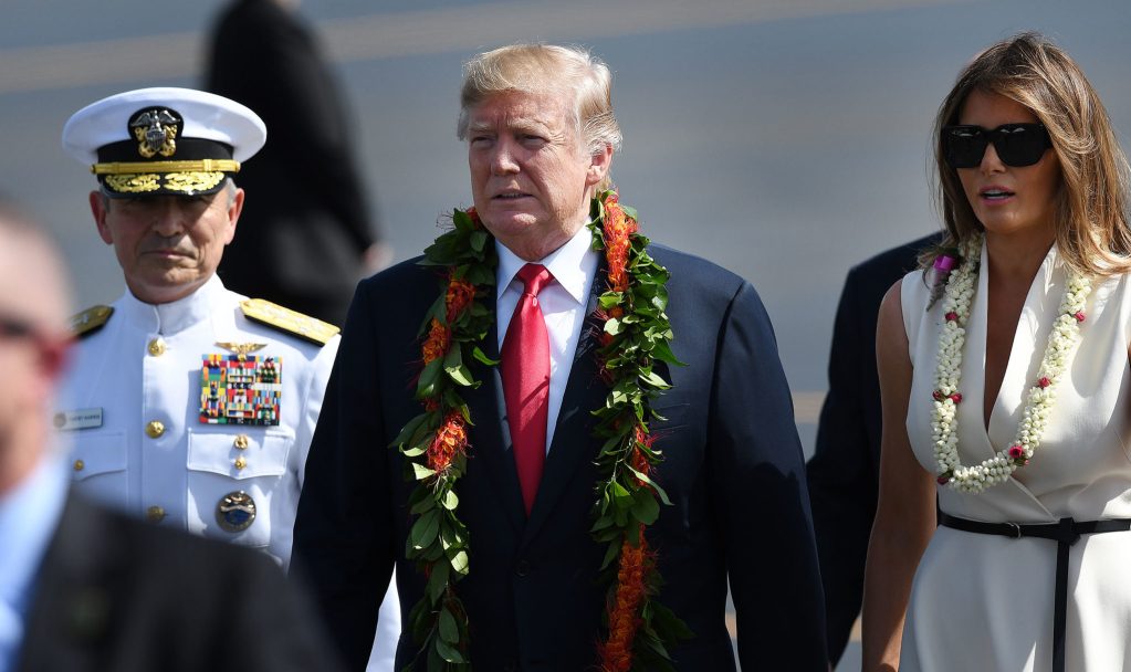 Trump in Hawaii. Admiral Harry Harris, President Donald Trump and First Lady Melania Trump walk towards people waiting for them at Joint Base Hickam Pearl Harbor.