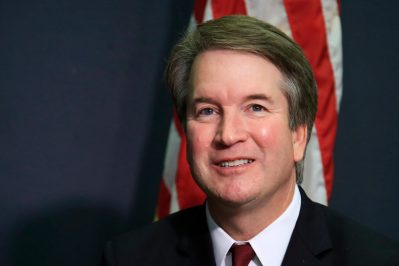 FILE - In this July 19, 2018, file photo, Supreme Court nominee Brett Kavanaugh glances at reporters during a meeting with Sen. James Lankford, R-Okla., on Capitol Hill in Washington. Kavanaugh has been a conservative team player, and the Supreme Court nominee has stepped up to make a play at key moments in politics, government and the law dating to the Bill Clinton era. (AP Photo/Manuel Balce Ceneta, File)