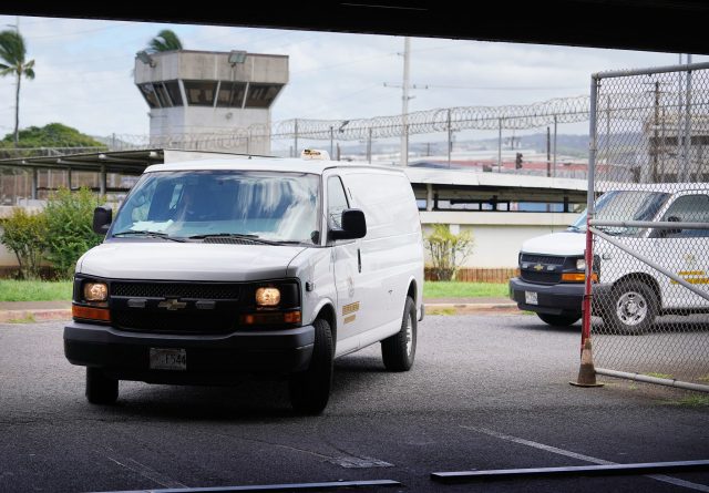 Vans with prisoners arrive at Oahu Community Corrections Center OCCC intake area.