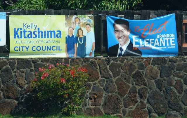 honolulu City Council candidate Kelly Kitashima and Brandon Elefante sign in Pearl City.