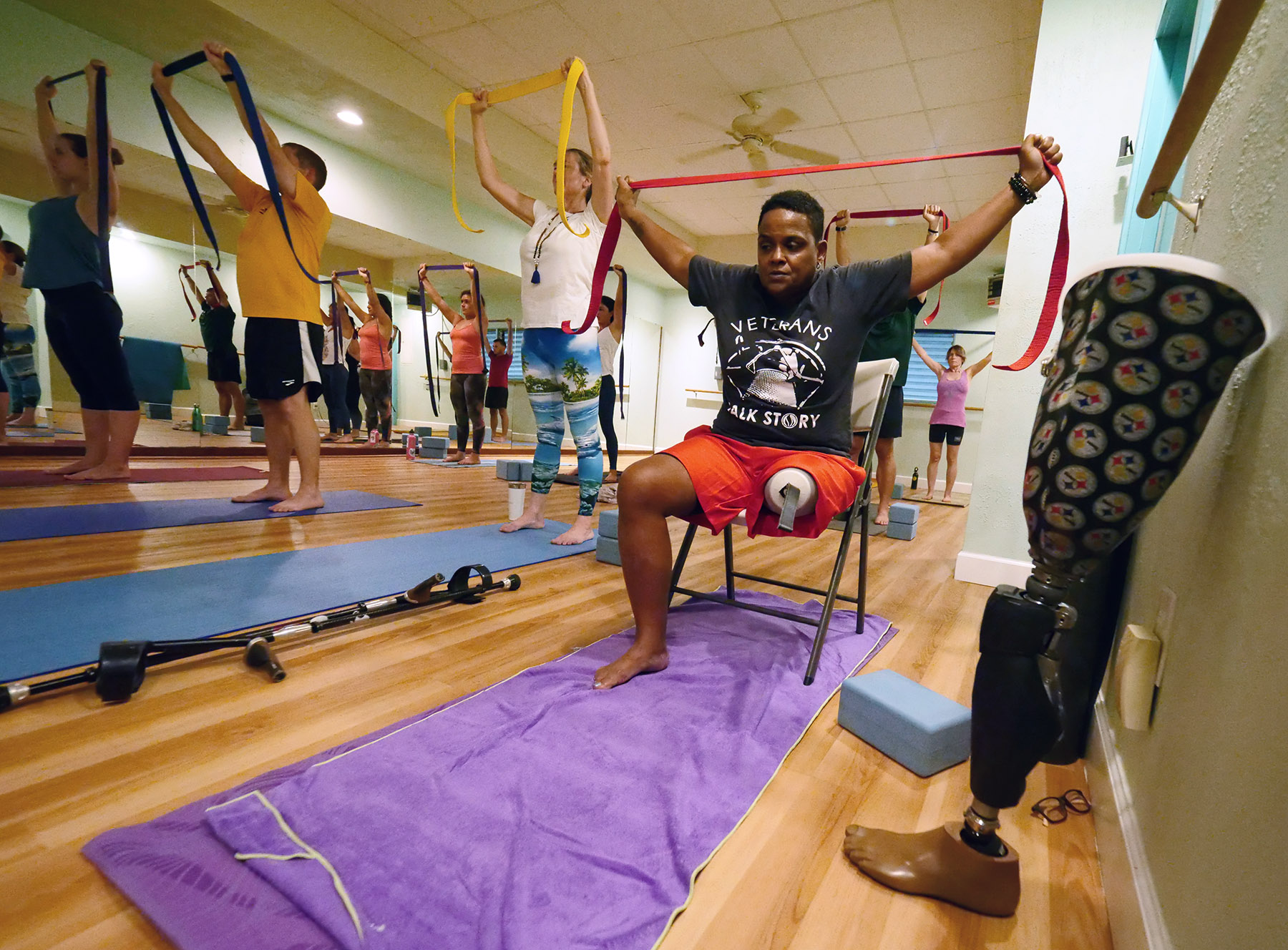 US veteran Cyndi Lee sits as she stretches during a yoga class designed specifically for veterans called Warriors At Ease at the Bella Kai Yoga Studio in Kailua, Wednesday, November 7, 2018. (Civil Beat photo Ronen Zilberman)