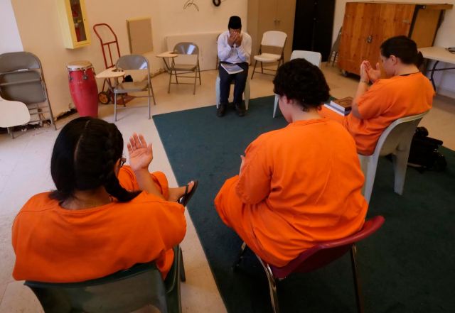 Matiullah Joyia, an imam with the Ahmadiyya Muslim Community shares information about his faith with women at the Women's Community Correctional Center in Kailua, HI on Sunday, December 2, 2018. Joyia recently moved to the island and is working to build a community here. Ahmadis have been subject to persecution throughout history and this is the first initiative to start a congregation on Oahu. (Civil Beat photo Ronen Zilberman)