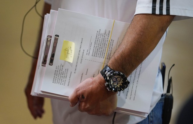 Tracy Yoshimura holds documents to file at Court Clerk office.