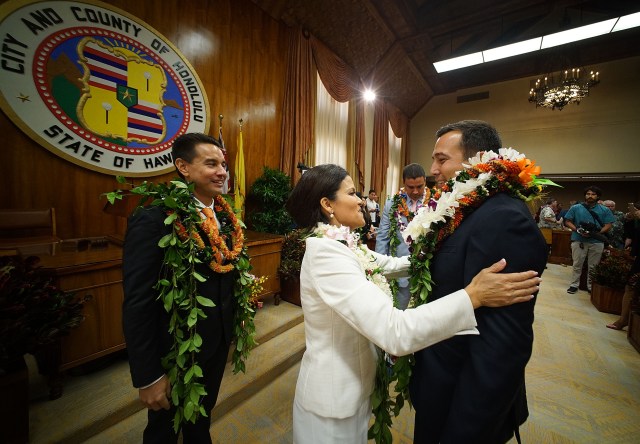 Honolulu City Council Member Trevor Ozawa is greeted by Chair Kymberly Pine after recess.