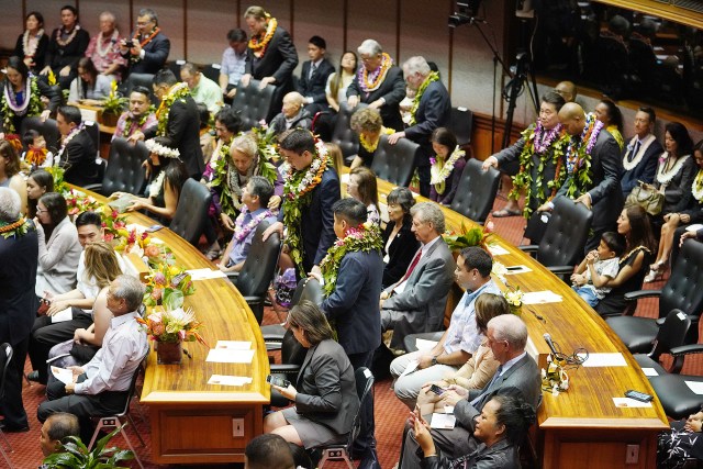 House Members bedecked in lei on the house floor at the Capitol on opening day.