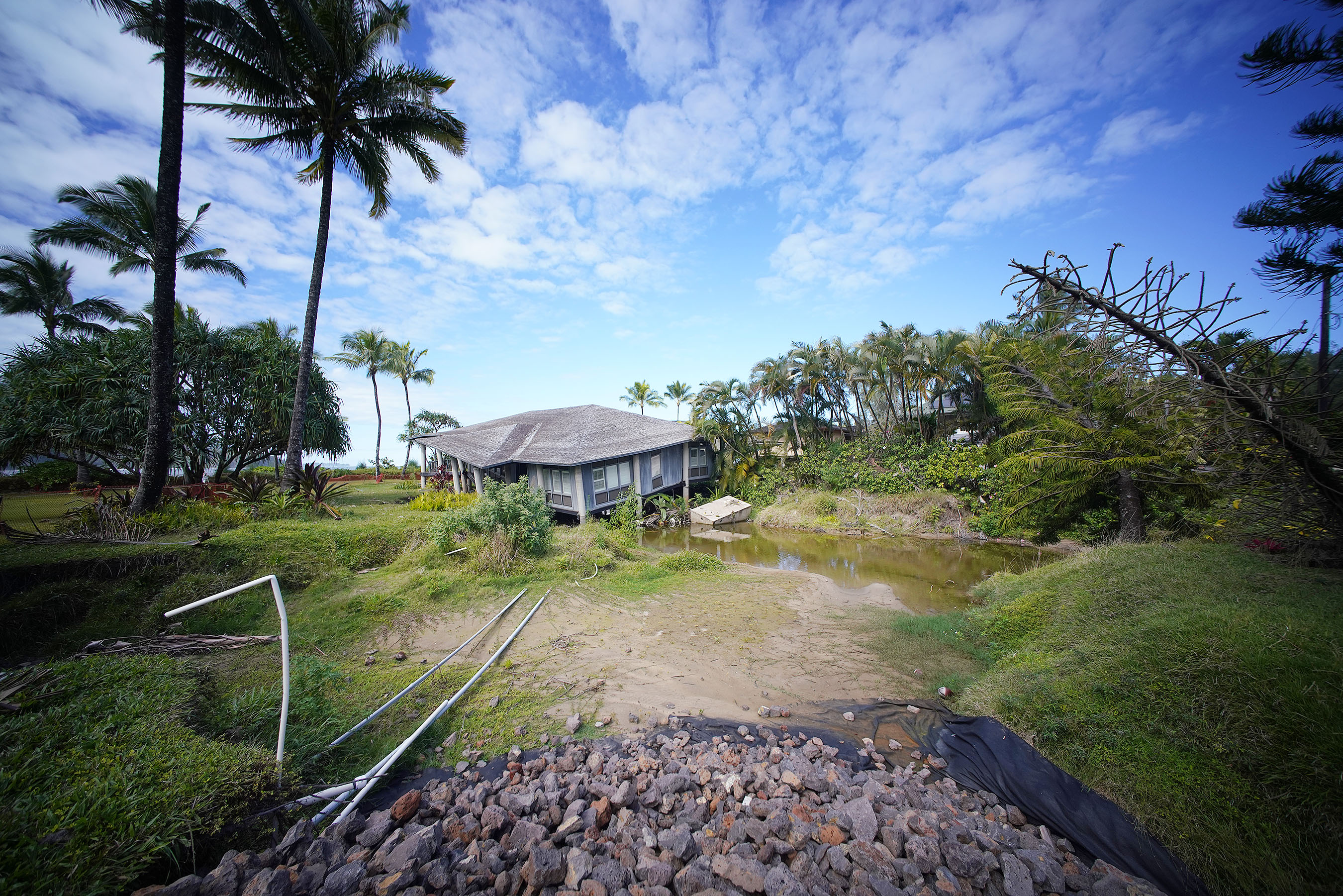 Home along Weke Road damaged from last year's flood sit along Hanalei Bay.