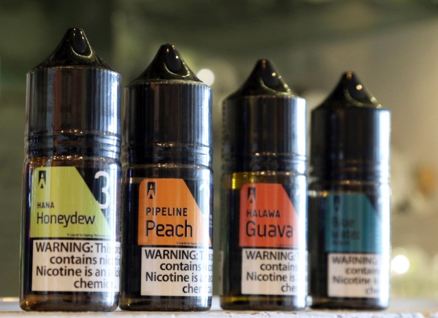 This Wednesday, March 27, 2019 photo shows a selection of e-liquid flavors like Hana Honeydew and Pipeline Peach on a counter at a VOLCANO Fine Electronic Cigarettes store in Aiea, Hawaii. Hawaii lawmakers are considering outlawing flavored tobacco and electronic cigarette liquids like Maui Mango and Cookie Monsta in an effort to stop escalating teenage vaping. (AP Photo/Audrey McAvoy)
