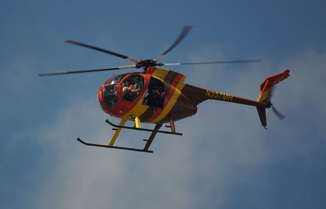 Magnum Helicopters Hughes 500D aircraft leaves Daniel Inouye International Airport.