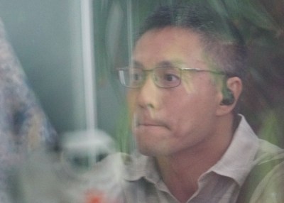 Bobby Nguyen waits outside District Court.