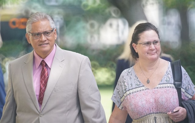 Former HPD Chief Louis Kealoha and Katherine Kealoha walk towards the District Court entrance.