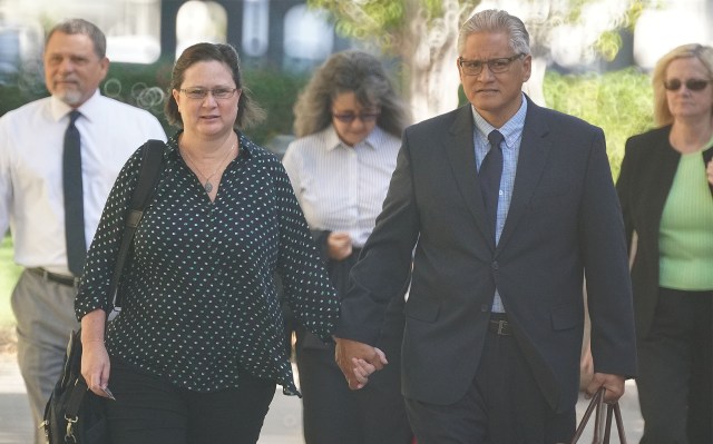 Former HPD Chief Louis Kealoha and Katherine Kealoha walk towards District Court.