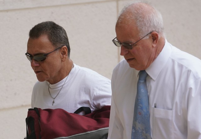 Left, Gerard Puana walks with Eric Seitz on arrival at District Court.