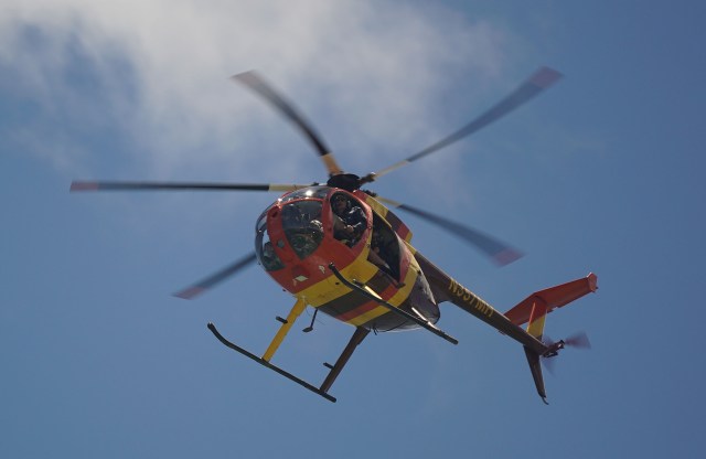 Magnum Helicopters open door tour flies over Ala Moana Beach.