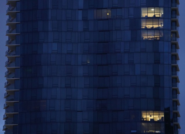 Waiea Condominium in Kakaako with very few lights on.