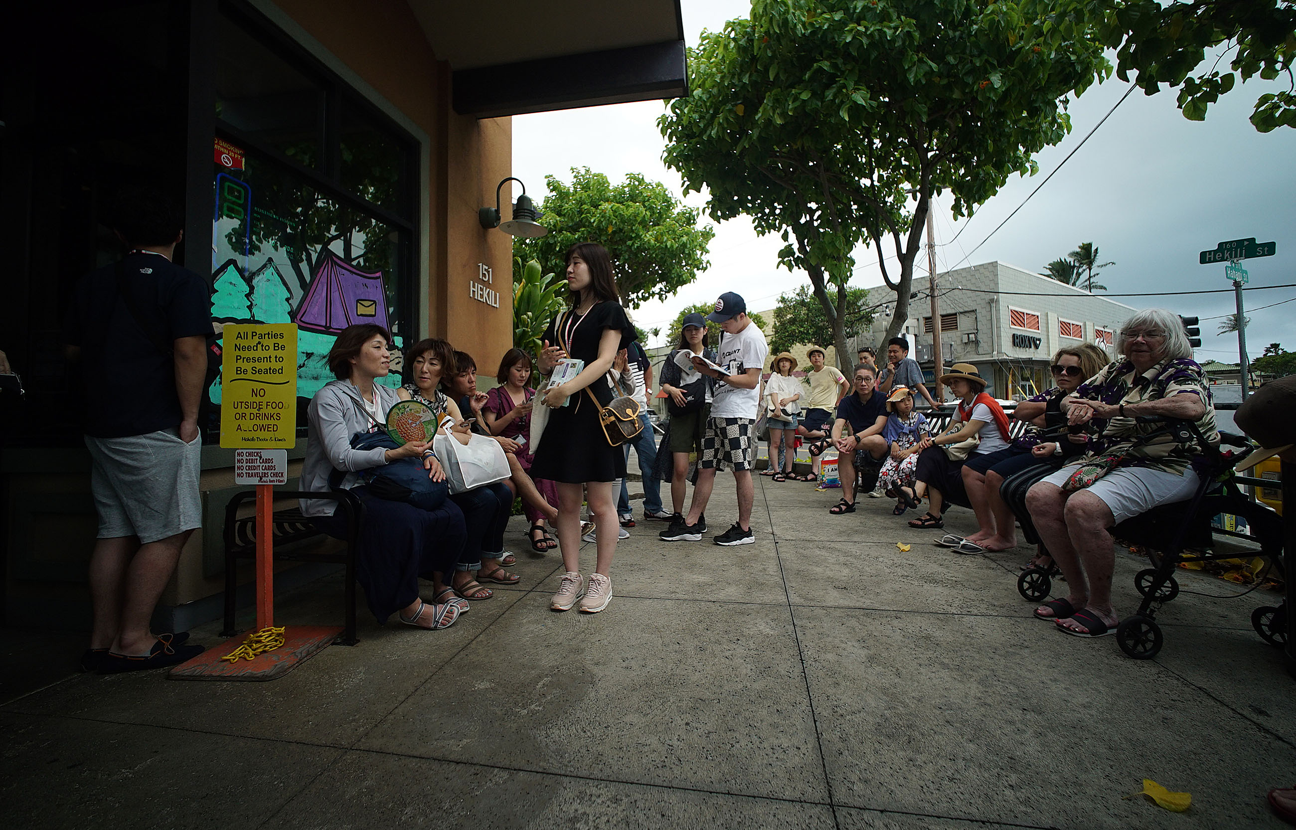Boots and Kimo as scores waiting for a table outside the Kailua breakfast eatery.