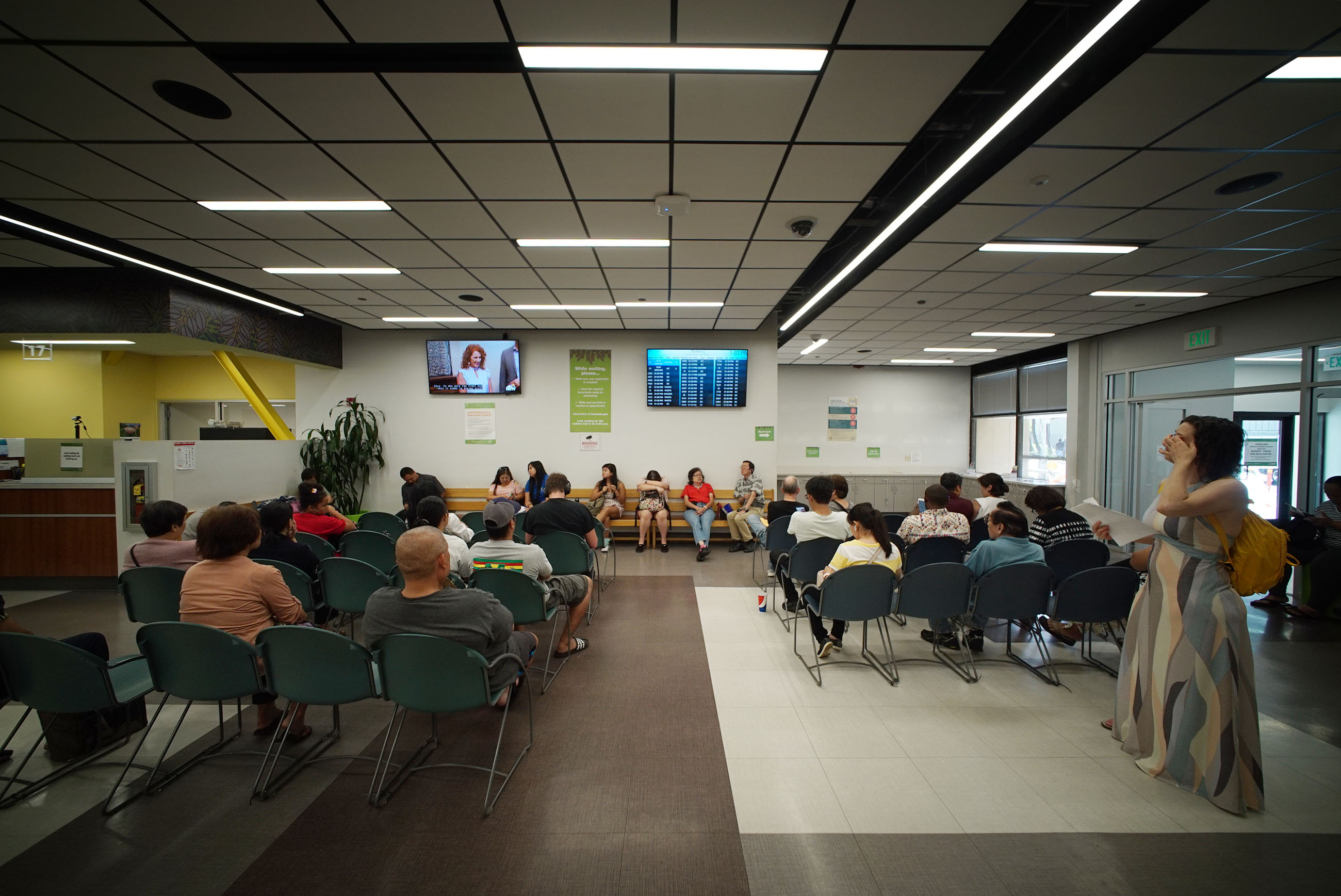 Kapalama Driver License Center with scores of people wait their turn as their AlohaQ number pops onto the large display and announced on the PA system.