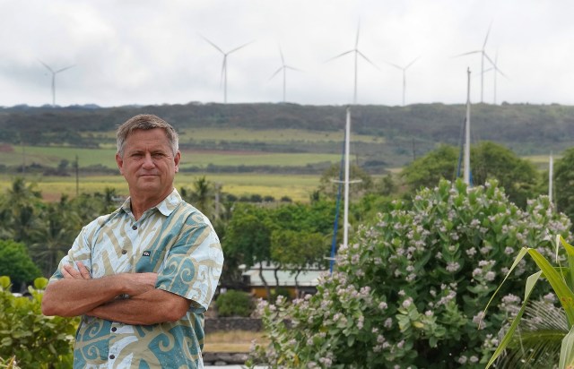 Senator Gil Riviere stands at Alii Park in Haleiwa with windmills above Waimea Bay.