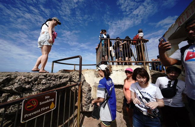 Visitors at the Diamond Head summit lookout enjoy views on a beautiful day.