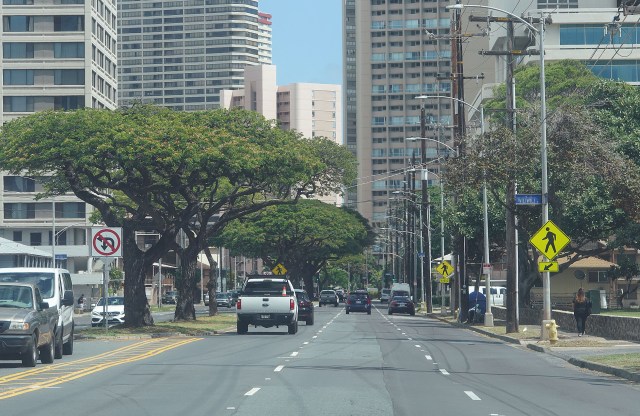 Right, yellow sign, Wiliwili Street Crosswalk sign with no painted cross walk on Kapiolani Boulevard. The city seems to have painted over about 45 crosswalks.