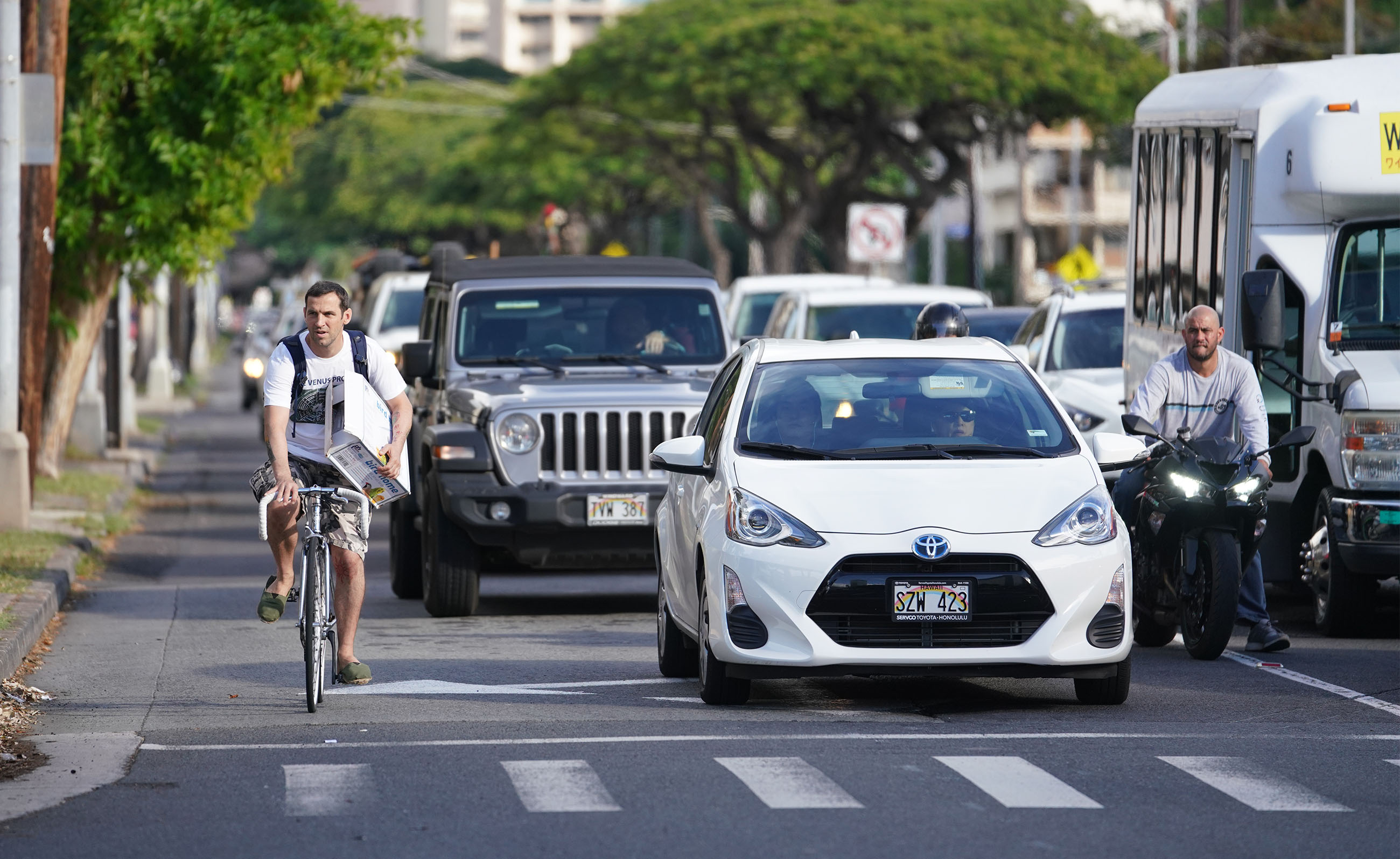 Cyclist in traffic on Kapiolani Boulevard near McCully.