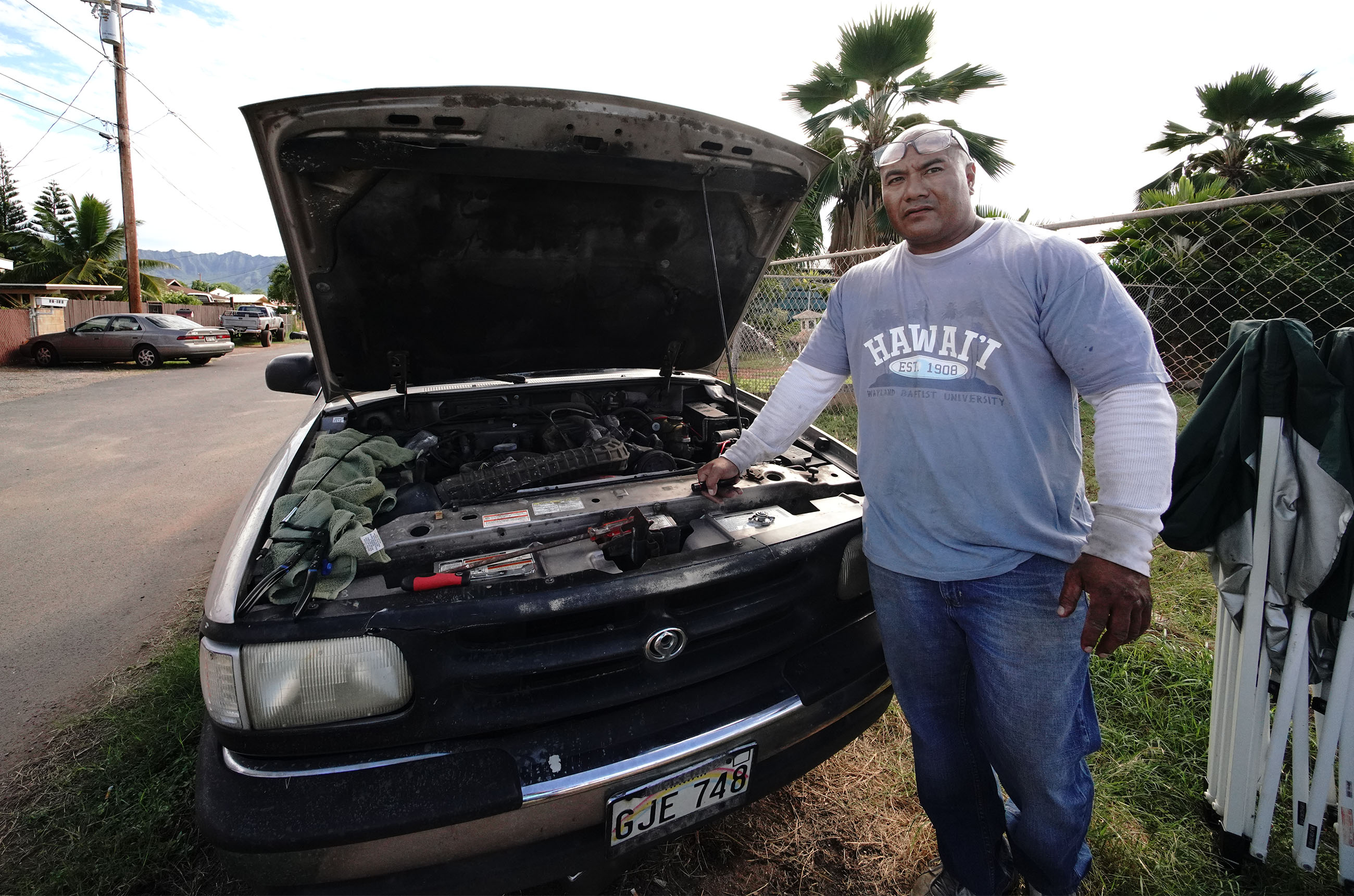 Sefo Fatai works on a truck in Waianae before he started working on a truck. Sefo is a trained automobile mechanic and has to do masonry to make ends meet.