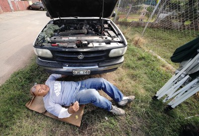 Sefo Fatai works on a truck in Waianae. Sefo works in masonry although he is a trained mechanic.