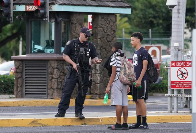 Military Police check IDs at Pearl Harbor Nimitz Gate after gates were reopened. Earlier a gunman killed two and injured another person.