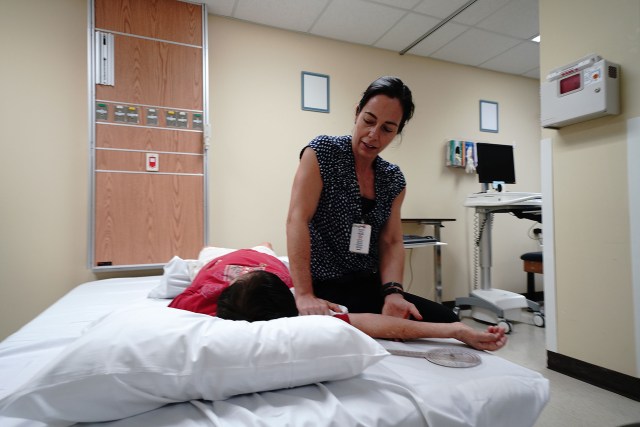 Wahiawa General Hospital Valerie Franck PT DPT Director of Physical Therapy works with patient.