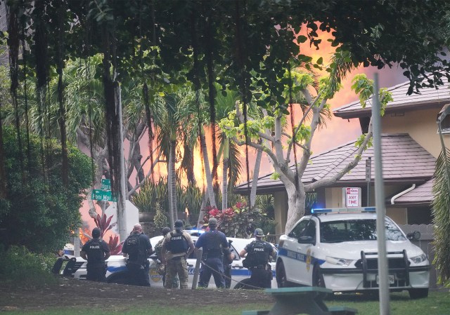 HFD and Honolulu Police Department officers respond to a shooting near La Pietra. Police watch as fire erupts from homes nearby.