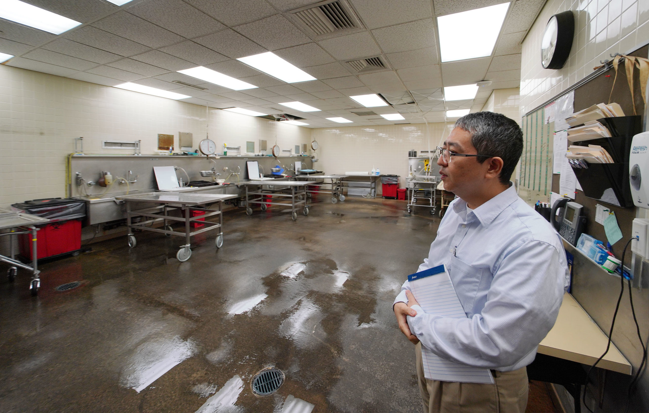 Medical Examiner Medical Examiner Dr Kobayashi stands in morgue.