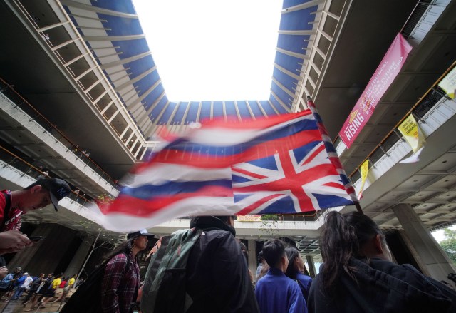 Opening Day of 2020 Legislature flag 9 year old Kawai Kupahu from Kailua holds an upside down flag in the Capitol Rotunda.