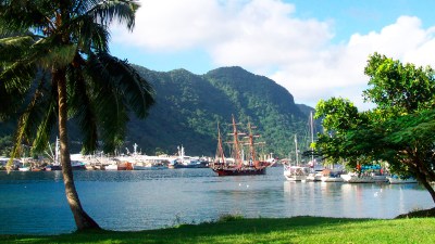 FILE - This July 2002 file photo shows a sailing ship in the harbor at Pago Pago, American Samoa. Many residents of American Samoa are concerned that a federal judge's recent ruling in Utah, saying those born in the U.S. territory should be recognized as U.S. citizens, could threaten "fa'a Samoa," the Samoan way of life, which includes cultural traditions like prayer curfews, communal living and a belief that the islands' lands should stay in Samoan hands. (AP Photo/David Briscoe, File)